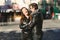 Couple in love embraced in an urban scene, with unfocused background and copy space