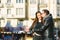 Couple in love embraced in an urban scene, with unfocused background and copy space