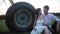 Couple in love embraces under the water drops near agricultural sprayer