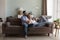 Couple in love enjoy conversation resting on sofa at home