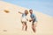 Couple in love enjoying dunes at beach