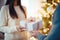 A couple in love exchanges gifts at home against the backdrop of a Christmas tree