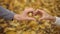 Couple in love folding their hands in shape of heart and interlacing fingers