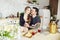 Couple in love has Breakfast in the kitchen early in the morning. Hugs and kisses, sexy girl in Bathrobe and man. Weekend morning