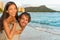 Couple in love having fun piggybacking on Hawaii beach. Healthy people portrait girlfriend and boyfriend hugging happy