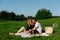 Couple in love having a picnic in a countryside on a green grass