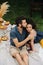 Couple in love, having picnic on lawn in their courtyard, looking at each other