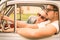 Couple in love having a rest during honeymoon vintage car trip
