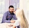 Couple in love holds cups of coffee at table.