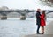 Couple in love hugging near Pont des Arts in Paris
