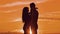 Couple in love hugging at sunset sunlight silhouette. family love concept love. Couple man and girl silhouettes of love