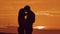 Couple in love hugging at sunset sunlight silhouette. family love concept love. Couple man and girl silhouettes of love