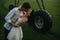 Couple in love kisses under water drops from agricultural sprayer