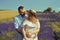 Couple in love kissing in a lavender field. Romance and travel, love. A pretty girl in a dress and a straw hat, and a man