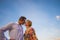 Couple in love kissing portrait with summer clothes and clear sky