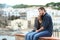 Couple in love looking away on a ledge on vacation