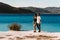 A couple in love looks at the blue lagoon. Couple in love on the beach. Honeymoon lovers. Man and woman on the island.