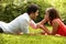 Couple in love lying on the grass in the park