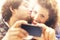 Couple in love making a selfie while him giving her a kiss