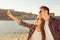 Couple in love making selfie photo at the seaside, close-up photo