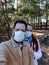 A couple in love in a medical mask takes a selfie on a smartphone