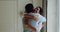 Couple in love meeting hugging after long separation standing indoors