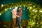 Couple in love near christmas background. Young couple kissing near Christmas tree. Low key. Silhouette