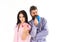 Couple in love in pajama, bathrobe stand back to back. Couple, family on sleepy faces in morning routine. Morning energy