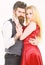 Couple in love, passionate dancers in elegant clothes, white background. Woman in red dress and man in vest. Dancing