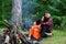 Couple in love at picnic in forest, trees on background.