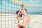 Couple in love play volleyball on sunny beach. Summer vacation and travel on holiday in Miami. Love and flirting of