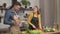 Couple in love preparing vegetarian food in home kitchen, husband feed beloved wife with pizza talking enjoy date cooking together