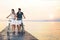 Couple in love pushing bike on a boardwalk at the sea