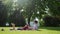 Couple in love relax on lawn while picnic. Guy reading his girl interesting book