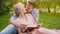 Couple in love sitting on rug reading book together, gently kissing in breaks