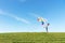 Couple in love. Smiling asian young man is holding girlfriend in his arms with multi color balloon minimal on the field meadow on