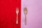 Couple of love, spoon, fork on pink and red tablecloth texture background, Valentine`s day holiday celebration