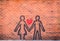 Couple in love sprayed paint on red brick wall