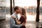 Couple in love standing together on the background of lake