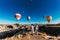 Couple in love stands on background of balloons in Cappadocia. The couple travels the world. Vacation in Turkey. Honeymoon trip.