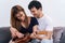 Couple in love. Stunning sensual portrait of young couple indoors. Attractive young man playing ukulele for his beloved