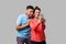 Couple in love taking picture together! Portrait of happy beautiful woman doing selfie with boyfriend. isolated on gray background