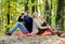 Couple in love tourists relaxing picnic blanket. Man with binoculars and woman with metal mug enjoy nature park. Park