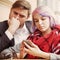 Couple in love while traveling monitoring their stock prices remotely with smart phone