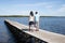 couple in love in vacation walk on pontoon lake beach