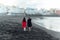 Couple in love walking on the beach near the powerful ocean with the sunset in Puerto de la cruz