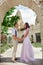 Couple in love walks and hugs on beautiful streets ancient city on summer day. Wedding couple waiting wedding ceremony