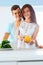 Couple in love washing vegetables in the kitchen