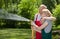 Couple in love watering grass