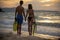 Couple lover holding hands together on the beach during sunset on honeymoon trip at tropical summer island. Honeymoon adventure